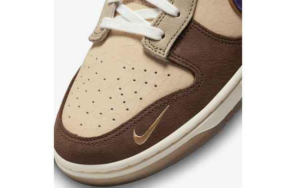 同时鞋舌、鞋领口和鞋头的麂皮运用潮牌信息了深棕与 Nike Swoosh 变形成的鬼脸 Logo 形成对比（大恶魔 Dunk Low 全新“Setsubun”配色鞋款即将来袭）